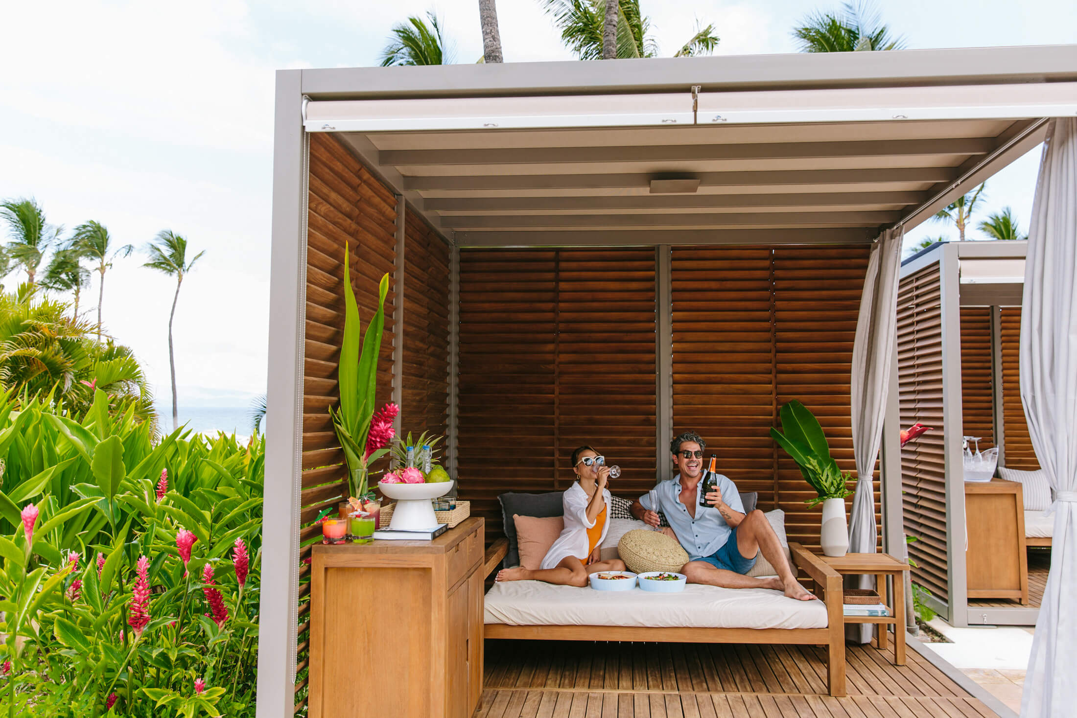 a couple sits in a cabana 