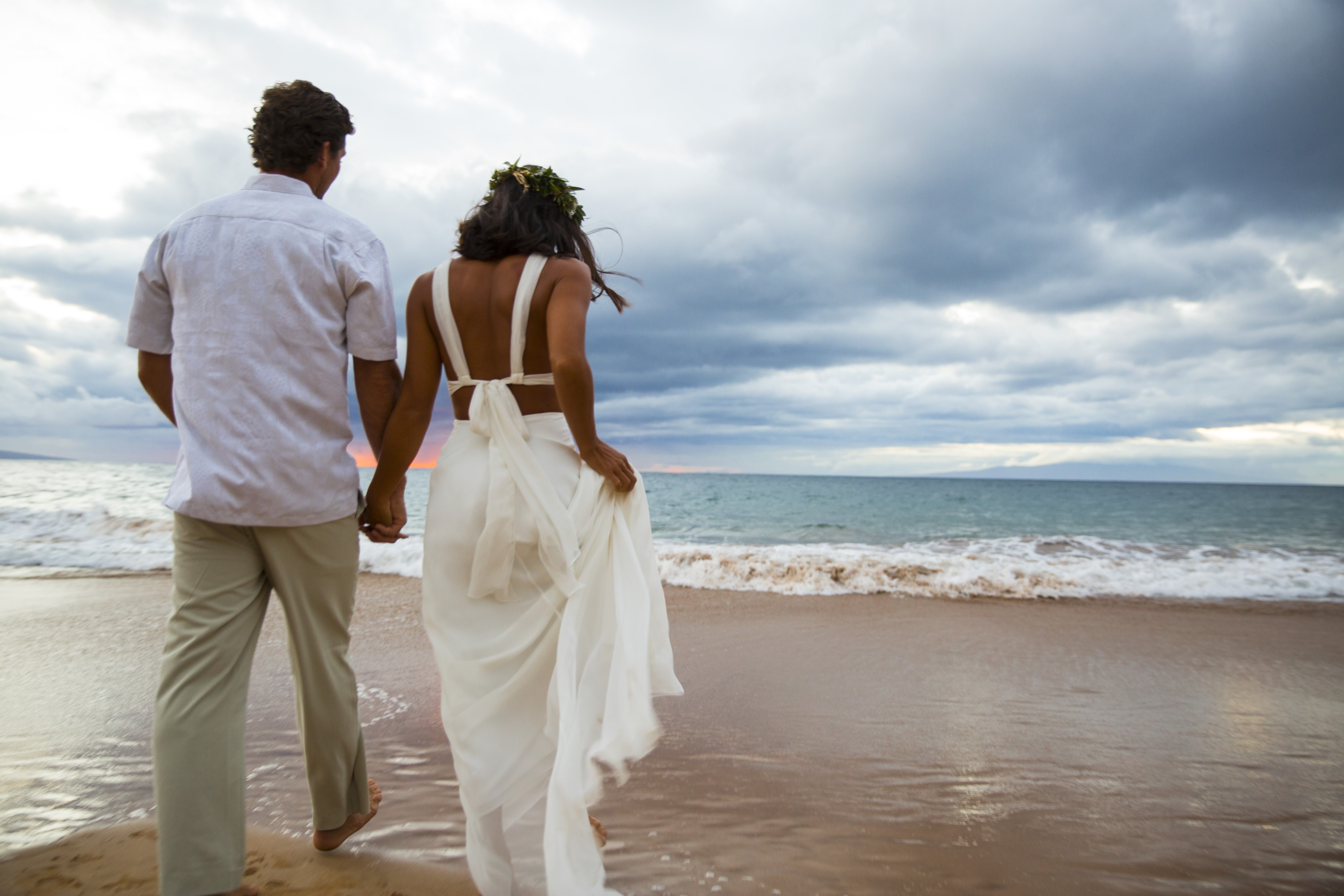 couple walking on beach wedding