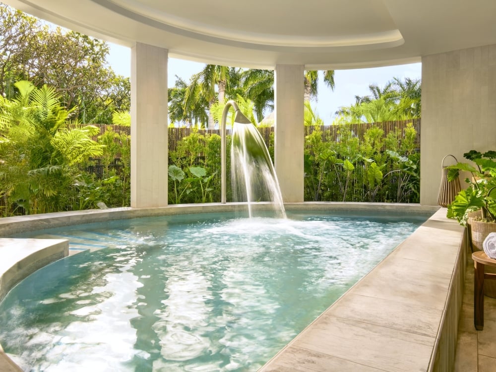 A semi-indoor hydrothermal pool next to a garden