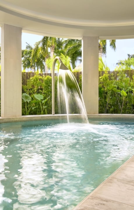 A semi-indoor hydrothermal pool next to a garden