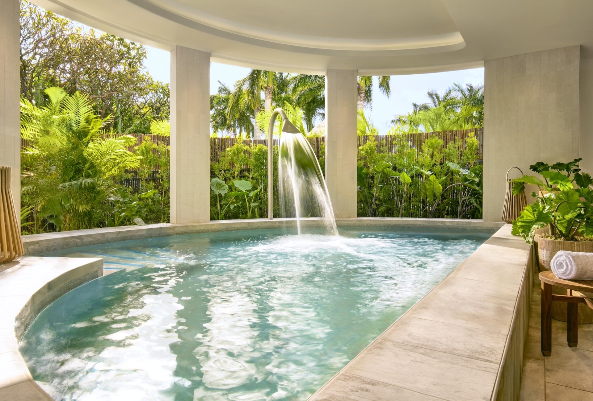 A semi-indoor hydrothermal pool next to a garden